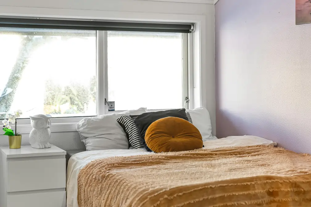 Sypialnia z granatową zwiniętą roletą materiałową w Władysławowie